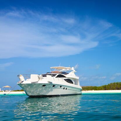 Luxury yachts anchored in a Tropical island turquoise beach. Francisqui cay. Boats, sailboats and yachts anchored in a Caribbean island. Travel and leisure related images for vacations in the Caribbean. Image taken at Los Roques, Venezuela. Los Roques is an archipelago or group of small islands located at 80 miles north of the Venezuelan coastline and a very popular destination for leisure, diving, kite surfing and all king of water activities. Los Roques and the beauty of the turquoise coastal beaches of Venezuela are almost indistinguishable from those of the Bahamas, Fiji, Bora Bora, French Polynesia, Malau, Hawaii, Cancun, Costa Rica, Florida, Maldives, Cuba, Puerto Rico, Honduras, or other tropical areas.