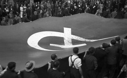 Un grupo de manifestantes porta una bandera comunista, en una marcha en Barcelona en octubre de 1936. 