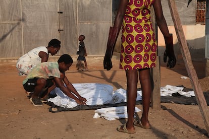 Making batik by hand in Ghana. The girl standing up is wearing the traditional “Nsu Bura” print.