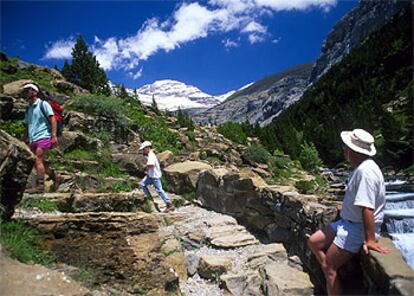 Senderistas, junto a las cascadas del río Arazas, en el parque nacional de Ordesa y Monte Perdido (Huesca).