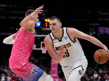 Denver Nuggets center Nikola Jokic (15) drives around Washington Wizards center Kristaps Porzingis (6) during the second half of an NBA basketball game Wednesday, March 22, 2023, in Washington.