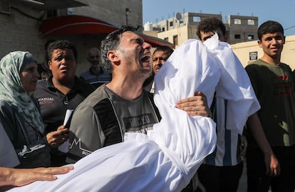 The body of a Palestinian killed in an Israeli airstrike is taken from the Al-Aqsa Hospital morgue for burial in Rafah, Gaza, on Sunday.