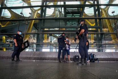 Agentes de Polica Nacional piden la documentacin a una persona en las instalaciones de la T4 del Aeropuerto Adolfo Surez Madrid-Barajas, en Madrid (Espa?a).