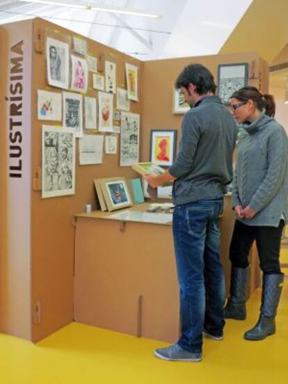 Artistas y visitantes charlan sobre las ilustraciones, que se venden desde 10 euros.