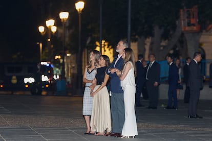 El rey Felipe, la reina Letizia y sus hijas, la princesa Leonor y la infanta Sofía, observan la proyección de un videomapping en la fachada de la Puerta del Príncipe del Palacio Real.