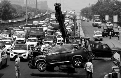 Una grúa retira un automóvil después de un accidente en la autopista Delhi-Gurugram (India) en junio de 2021.