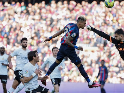 Barcelona's Raphinha scores his side's opening goal during Spanish La Liga soccer match between Barcelona and Valencia at the Camp Nou stadium in Barcelona, Spain, Sunday, March 5, 2023. (AP Photo/Joan Monfort)