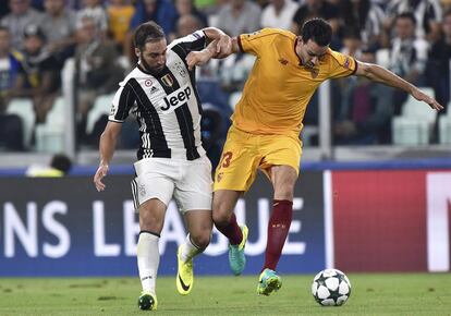 Gonzalo Higuain (i) de la Juventus de Turin lucha por el balón con Adil Rami del Sevilla.