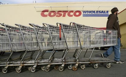 A Costco employee pulls shopping carts at a US branch of the store.