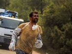 A Turkish volunteer runs as he heads to fight wildfires in Turgut village, near the tourist resort of Marmaris, Mugla, Turkey, Wednesday, Aug. 4, 2021. As Turkish fire crews pressed ahead Tuesday with their weeklong battle against blazes tearing through forests and villages on the country's southern coast, President Recep Tayyip Erdogan's government faced increased criticism over its apparent poor response and inadequate preparedness for large-scale wildfires.(AP Photo/Emre Tazegul)