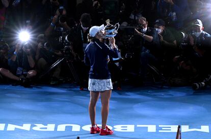 FILE PHOTO: Tennis - Australian Open - Women's Singles Final - Melbourne Park, Melbourne, Australia - January 29, 2022 Australia's Ashleigh Barty poses with the trophy as she celebrates winning the final against Danielle Collins of the U.S. REUTERS/Morgan Sette/File Photo