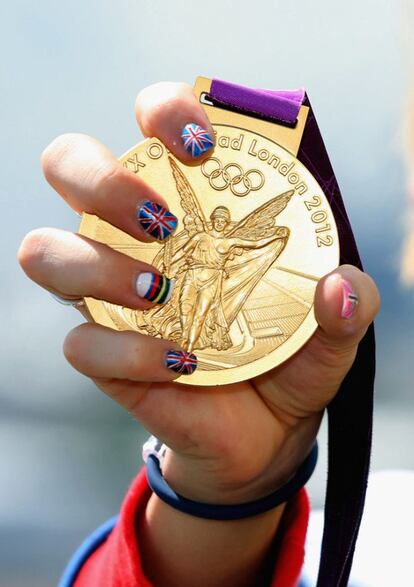 Laura Trott, del equipo británico femenino de ciclismo en pista, levanta su medalla de oro.