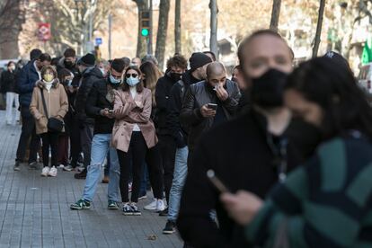 Una cola frente a un laboratorio de análisis clinicos para realizar tests rápidos y PCR, el domingo.