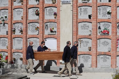 A burial at Madrid's La Almudena cemetery on Saturday.