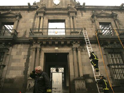 Un bombero escala la fachada de la sede del Obispado de Tenerife, en cuyo interior se declaró un incendio.