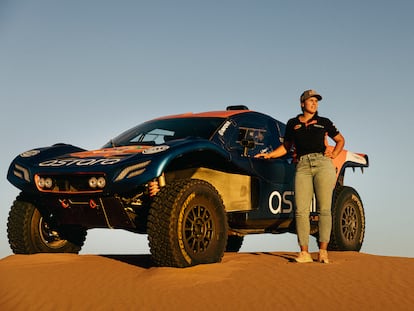 Laia Sanz poses with the ‘buggy’ she will drive during the 2024 Dakar Rally, a race across one of the largest dunes in the Moroccan Sahara.