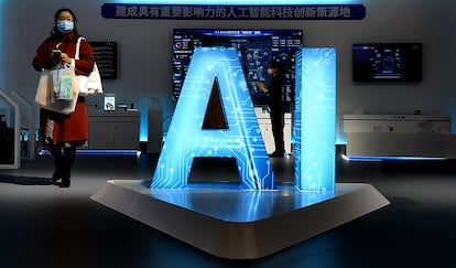 A woman walks through the artificial intelligence exhibition area of the 2021 World Manufacturing Conference in Hefei, China, on Nov. 19, 2021.