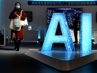 A woman walks through the artificial intelligence exhibition area of the 2021 World Manufacturing Conference in Hefei, China, on Nov. 19, 2021.