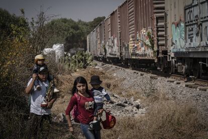 Alejandro Villalobos y Yesenia Ramírez caminan con sus dos pequeños hijos a un costado del tren que avanza en los límites del municipio de Chimalhuacán. La ruta que atraviesan es una de las más riesgosas del Estado de México, y comprende un promedio de 29 kilómetros hasta la Basílica de Guadalupe.