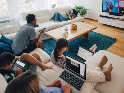 A family uses different technologies in their living room.