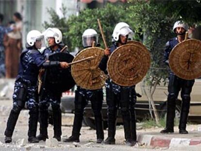 Agentes de policía palestinos se preparan para hacer frente a los manifestantes.