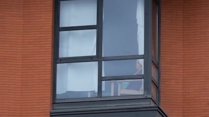 A resident looks out of a window at the Monte Hermoso senior home, where visits have been banned since March 8.