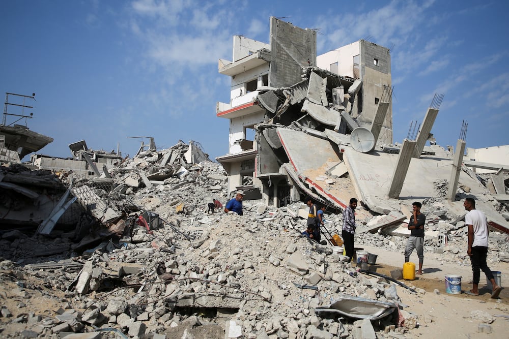 Palestinians stand next to the rubble of houses destroyed in previous strikes during the Israeli military offensive, amid the Israel-Hamas conflict, in Khan Younis in the southern Gaza Strip November 6, 2024. REUTERS/Hatem Khaled