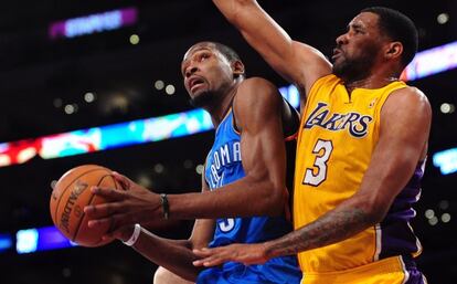 Shawne Williams intenta frenar a Durant.