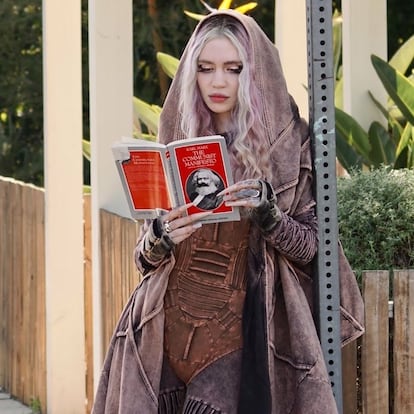 Grimes reading the ‘Communist Manifesto’ by Karl Marx.