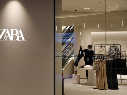 A staff member sorts clothes inside a clothing store of Inditex's Zara brand at a newly opened shopping mall in Beijing, China April 16, 2021.
