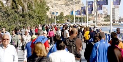 Turistas en el paseo mar&iacute;timo de la playa de El Postiguet (Alicante)