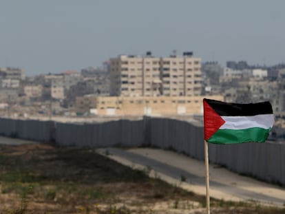 FILE - A Palestinian flag is seen with the background of a section of the wall in the Philadelphi corridor between Egypt and Gaza, on the background, near the southern Gaza Strip town of Rafah, Sunday, July 1, 2007. (AP Photo/Khalil Hamra, File)