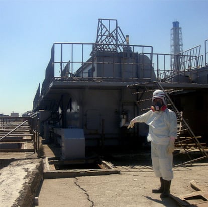 Un operario de Tepco muestra un agujero en el suelo cercano al edificio en el que se encuentra el reactor número dos de la central de Fukushima.
