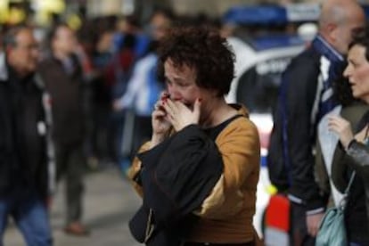 A woman speaks on a cellphone outside the high school in Barcelona.