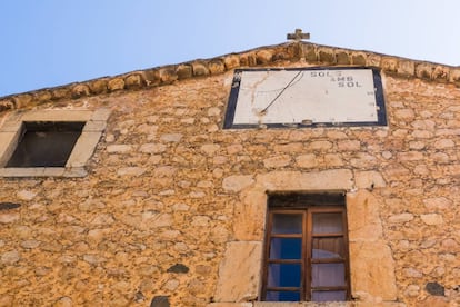 La fachada de la iglesia de Fornalutx, con un reloj solar y la leyenda 'Sols amb Sol'.