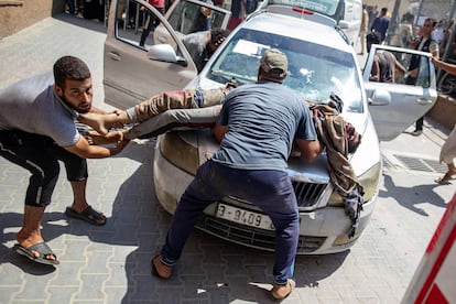 Men carry a wounded man to Nasser Hospital following the Israeli bombardment of Al Mawasi on Saturday. 