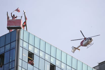 Un seguidor del equipo rojiblanco sigue las celebraciones desde lo alto de un edificio de Bilbao.