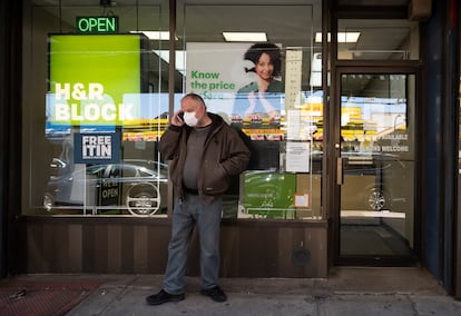 A man waits outside an H&R Block tax preparation office on April 6, 2020, in the Brooklyn borough of New York.