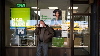 A man waits outside a H&R Block tax preparation office on Monday, April 6, 2020, in the Brooklyn borough of New York. Tax season is here again.