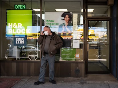 A man waits outside a H&R Block tax preparation office on Monday, April 6, 2020, in the Brooklyn borough of New York. Tax season is here again.