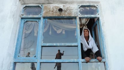 La viuda afgana Bibikoh se asoma a la ventana de su casa en Zanabad.