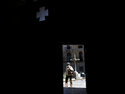 A woman enters the door of the Church of La Merced, in La Paz, Bolivia