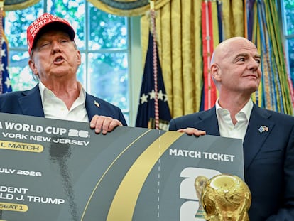 US President Donald Trump, left, and FIFA president Gianni Infantino hold a ticket to the final 2026 FIFA World Cup match in the Oval Office on August 22, 2025.