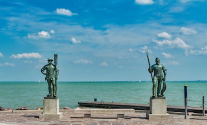The statues of the fisherman and the ferryman were created in 1941 by Janos Pasztor, Balatonfuered, Veszprem County, Central Transdanubia, Hungary