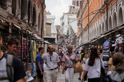 Tourists walk in a crowded street in Venice, Italy, Wednesday, Sept. 13, 2023.