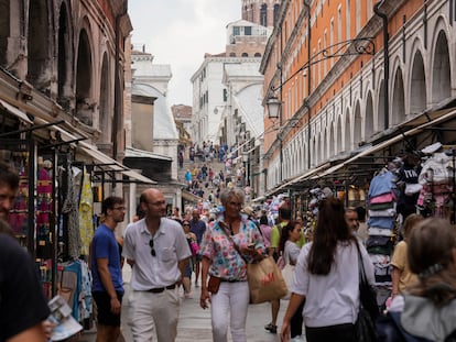 Tourists walk in a crowded street in Venice, Italy, Wednesday, Sept. 13, 2023.