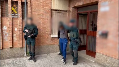 Dos guardias civiles custodian al presunto yihadista detenido el pasado 2 de abril en Murcia en la Operación Marhap, en una imagen facilitada por el instituto armado.