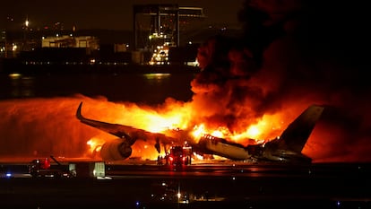 Firefighters work at Haneda International Airport after the Japan Airlines A350 plane crash in Tokyo, Japan, January 2. 