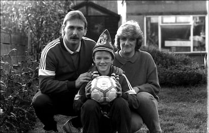 David Beckham, con 11 años, en el jardín de sus casa en el barrio londinense de Leystone acompañado de sus padres Ted y Sandra