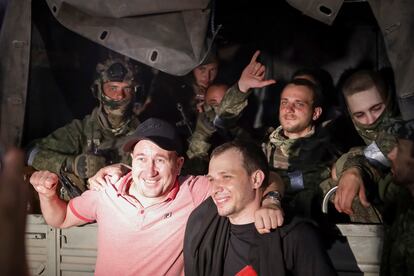 Two men pose with Wagner mercenaries in Rostov-on-Don, in southwestern Russia, on Saturday.